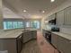 Modern kitchen with gray cabinets, granite countertops, and stainless-steel appliances offering a sleek and functional design at 142 Asa Moseley Rd, Mcdonough, GA 30252