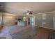 Spacious living room with a ceiling fan, neutral walls, and a seamless open flow to the kitchen area at 142 Asa Moseley Rd, Mcdonough, GA 30252