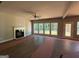 Cozy living room with a fireplace, abundant natural light, and new floors, creating a warm and inviting ambiance at 142 Asa Moseley Rd, Mcdonough, GA 30252