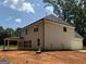 New home's rear exterior, featuring a covered porch and ample natural light, perfect for outdoor enjoyment at 142 Asa Moseley Rd, Mcdonough, GA 30252