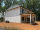 Back of new construction with a covered porch, showcasing its architectural details and outdoor living space at 142 Asa Moseley Rd, Mcdonough, GA 30252