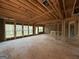 Unfinished interior with exposed framing, large windows, and natural light at 142 Asa Moseley Rd, Mcdonough, GA 30252