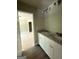 Bathroom with double sinks, granite countertops, and a view into a bedroom at 150 Asa Moseley Rd, Mcdonough, GA 30252