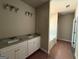 Bathroom featuring double sinks, granite countertops, and modern lighting at 150 Asa Moseley Rd, Mcdonough, GA 30252