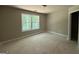 A bright bedroom with a large window offering views of lush greenery at 150 Asa Moseley Rd, Mcdonough, GA 30252