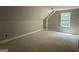 An upstairs bedroom with neutral walls, white trim, and a dormer window at 150 Asa Moseley Rd, Mcdonough, GA 30252