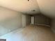 An attic space with potential for a bedroom and featuring multiple doors at 150 Asa Moseley Rd, Mcdonough, GA 30252