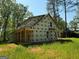 New construction with wrap-around porch detail, siding not yet installed, in wooded setting at 150 Asa Moseley Rd, Mcdonough, GA 30252