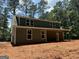Charming home showcasing a covered porch and vertical siding under a blue sky at 150 Asa Moseley Rd, Mcdonough, GA 30252