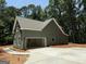 Home exterior featuring a detached garage and concrete driveway with ample parking at 150 Asa Moseley Rd, Mcdonough, GA 30252