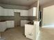 Unfinished kitchen with white cabinets, granite countertops and a view into the living room at 150 Asa Moseley Rd, Mcdonough, GA 30252
