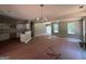 Open living area with neutral walls and wood flooring leading into the kitchen at 150 Asa Moseley Rd, Mcdonough, GA 30252