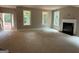 Open living room area featuring a fireplace, large windows and access to the home's entry at 150 Asa Moseley Rd, Mcdonough, GA 30252