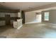 Spacious living room with an open floor plan and view into the kitchen space at 150 Asa Moseley Rd, Mcdonough, GA 30252