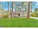 Ranch style home with a spacious lawn and mature trees at 3006 Remington St, East Point, GA 30344