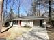 House exterior showcasing a red front door and a paved driveway at 3006 Remington St, East Point, GA 30344