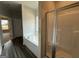 Bathroom features a soaking tub next to a window and a glass-enclosed shower at 136 Asa Moseley Rd, Mcdonough, GA 30252