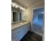 Bathroom features a double vanity with granite countertops and modern lighting fixtures at 136 Asa Moseley Rd, Mcdonough, GA 30252
