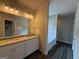 Bathroom featuring a double vanity with granite countertop and soaking tub at 136 Asa Moseley Rd, Mcdonough, GA 30252