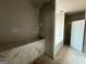 Bathroom under construction with white vanity covered in plastic and a bright white door at 136 Asa Moseley Rd, Mcdonough, GA 30252