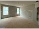 Unfinished bedroom features natural light and an attached ensuite bathroom providing a blank canvas for personalization at 136 Asa Moseley Rd, Mcdonough, GA 30252