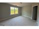 A bright bedroom features a window overlooking lush greenery, creating a serene and inviting atmosphere at 136 Asa Moseley Rd, Mcdonough, GA 30252