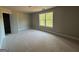 Bedroom featuring a bright window, neutral walls, and a ceiling light at 136 Asa Moseley Rd, Mcdonough, GA 30252