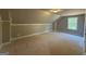 A finished bedroom in a home is brightened by a large window at 136 Asa Moseley Rd, Mcdonough, GA 30252