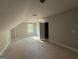 Bedroom with sloped ceilings and natural light from one window at 136 Asa Moseley Rd, Mcdonough, GA 30252