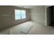 Spacious bedroom with drywall waiting to be finished and a view to the outdoors at 136 Asa Moseley Rd, Mcdonough, GA 30252