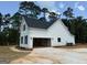 Home exterior with an open garage and walkway to the yard at 136 Asa Moseley Rd, Mcdonough, GA 30252