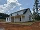 Exterior view of this home with a black roof and a covered patio at 136 Asa Moseley Rd, Mcdonough, GA 30252