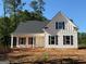 Charming new construction home with board and batten siding, black shutters, and covered front porch at 136 Asa Moseley Rd, Mcdonough, GA 30252