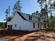 New home exterior features a garage and a covered porch, blending practicality and curb appeal at 136 Asa Moseley Rd, Mcdonough, GA 30252