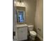 Charming half bathroom with granite countertop, white cabinetry, and modern fixtures at 136 Asa Moseley Rd, Mcdonough, GA 30252