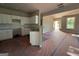 Kitchen with white cabinets, granite counters, stainless sink and view into living room at 136 Asa Moseley Rd, Mcdonough, GA 30252