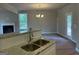 Bright kitchen with granite countertop, stainless steel sink, and view to spacious living area at 136 Asa Moseley Rd, Mcdonough, GA 30252