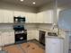 Updated kitchen with granite counters, stainless steel appliances, and modern white cabinetry at 136 Asa Moseley Rd, Mcdonough, GA 30252
