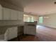 Bright kitchen with granite countertops, white cabinets, stainless sink and a view into the living room at 136 Asa Moseley Rd, Mcdonough, GA 30252