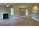 Spacious living room with a fireplace and direct access to a well lit outdoor space at 136 Asa Moseley Rd, Mcdonough, GA 30252