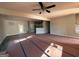 Open-concept living room showcases stairs, ceiling fan, view of the kitchen, and a light fixture at 136 Asa Moseley Rd, Mcdonough, GA 30252