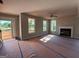 Expansive living room with a fireplace, natural light, and modern ceiling fan at 136 Asa Moseley Rd, Mcdonough, GA 30252