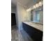 Bathroom with double vanity, granite countertop, and ample lighting at 148 Asa Moseley Rd, Mcdonough, GA 30252