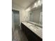 Bathroom featuring a double vanity with granite countertop and modern lighting at 148 Asa Moseley Rd, Mcdonough, GA 30252