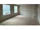 An unfinished bedroom with two bright windows and freshly painted walls at 148 Asa Moseley Rd, Mcdonough, GA 30252