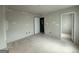 Bright bedroom with multiple doorways, electrical outlets, and neutral color at 148 Asa Moseley Rd, Mcdonough, GA 30252