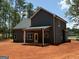 Exterior view of home with covered porch, displaying the backyard and home's design at 148 Asa Moseley Rd, Mcdonough, GA 30252