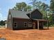 Rear exterior view of home with a covered porch, showcasing the backyard and architectural design at 148 Asa Moseley Rd, Mcdonough, GA 30252