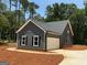 Charming home showcasing great curb appeal with gray siding and an attached garage at 148 Asa Moseley Rd, Mcdonough, GA 30252
