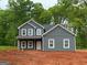 New two-story home featuring a gray exterior, white trim and a covered front porch perfect for relaxing at 148 Asa Moseley Rd, Mcdonough, GA 30252